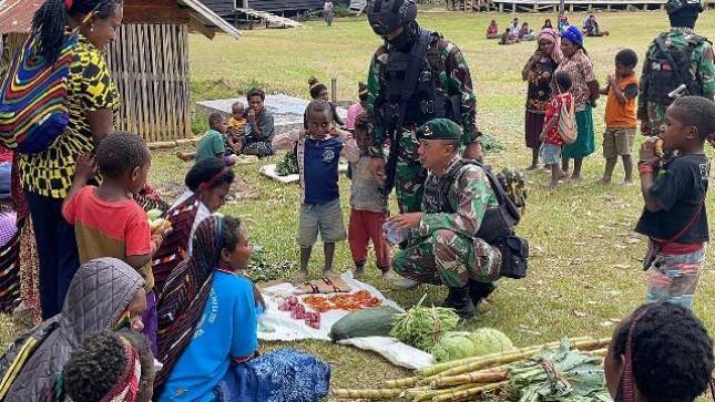 Satgas Yonif Mekanis 203 AK Membeli Hasil Bumi Masyarakat