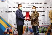 Direktur Enterprise & Business Service Telkom Edi Witjara (kanan) menyerahkan menyerahkan cindera mata kepada Kepala BPH Migas M. Fanshurullah Asa (kiri)