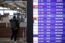 Seorang penumpang pesawat antre di loket dekat papan jadwal penerbangan di Terminal 3 Bandara Internasional Soekarno-Hatta, Tangerang, Banten, Jumat (7/1/2022). Pemerintah untuk sementara menutup pintu masuk bagi warga dari Afrika Selatan, Botswana, Norwegia, Prancis, Angola, Zambia, Zimbabwe, Malawi, Mozambique, Namibia, Eswatini, Lesotho, Inggris dan Denmark dalam upaya mencegah penyebaran Covid-19 tipe SARS-CoV-2 varian B.1.1.529 atau Omicron yang berlaku hari ini (7/1/2022). - (antarafoto)